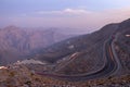 View from Jebael Jais mountain of Ras Al Khaimah emirate in the evening. United Arab Emirates, Light trails from the car Royalty Free Stock Photo