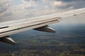 View of jet airplane wing landing at airport in bad weather. Travel and air transportation concept Royalty Free Stock Photo