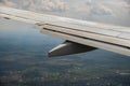 View of jet airplane wing landing at airport in bad weather. Travel and air transportation concept Royalty Free Stock Photo