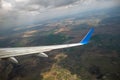 View of jet airplane wing landing at airport in bad weather. Travel and air transportation concept Royalty Free Stock Photo