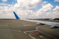 View of jet airplane wing taxiing runway after landing at airport. Travel and air transportation concept Royalty Free Stock Photo