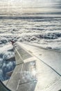 View of jet plane wing above the clouds Royalty Free Stock Photo