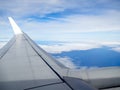 View of jet plane wing on the background of thick clouds Royalty Free Stock Photo