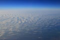 View of jet plane wing with cloud patterns Royalty Free Stock Photo