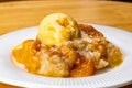 View of juicy homemade delicious peach cobbler with a scoop of vanilla ice cream Royalty Free Stock Photo