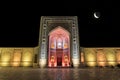 View of the Kalyan mosque on Registan square on a moonlit night in multi-colored lighting. Bukhara