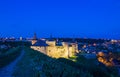 View on the Kamianets-Podilskyi castle in the evening. Beautiful stone castle on the hill on the sunset. Clouds in the darkening Royalty Free Stock Photo