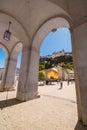 View of Kapitelplatz and Hohensalzburg castle through arches of the Catherdral.