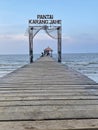 View of Karang Ginger beach, Central Java with a wooden bridge and hut in the middle with a clear sky in the background Royalty Free Stock Photo