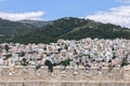 Kavala chaotic urban residential development on a forested hill through the battlements of the castle masonry