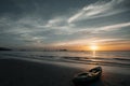 View of the kayak lies on the beach during a amazing sunset. Royalty Free Stock Photo