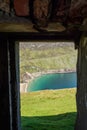 View on Keem beach from a door of an old building. Achill island, county Mayo, Ireland. Beautiful sandy beach with clear blue Royalty Free Stock Photo