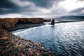 View on Kirkjufjara beach and Arnardrangur cliff. Location Atlantic ocean, Iceland, Europe