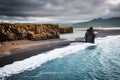 View on Kirkjufjara beach and Arnardrangur cliff. Location Atlantic ocean, Iceland, Europe