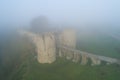 View of the Koporye fortress, thick morning fog. Koporye, Leningrad Region Royalty Free Stock Photo