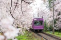 View of Kyoto local train traveling on rail tracks with flourish