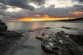 View of La Pelosa beach in Sardinia at sunrise with rocky reef in the foreground Royalty Free Stock Photo