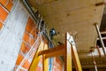 View on ladder and cable tray with bundle of cables between floors in building Royalty Free Stock Photo