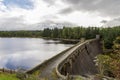 A view of Laggan Dam wall holding waters of the lock with a walkway in the center, Scotland