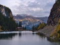 View of Lake Agnes in autumn with yellow colored larch trees and hikers at the tea house in valley in the Rocky Mountains, Canada.