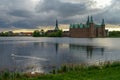 View of lake around renaissance Frederiksborg Castle with two sw Royalty Free Stock Photo