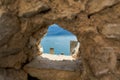 View of Lake Garda through a hole in the town wall in the resort of Limone Sul Garda Royalty Free Stock Photo