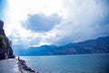 View of lake Garda. On the left you can see the castle on the mountain, in the middle of the composition of the clouds breaks out