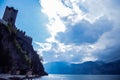 View of lake Garda. On the left you can see the castle on the mountain, in the middle of the composition of the clouds breaks out