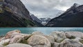 This view of Lake Louise includes the Rocky Mountains of Alberta, mineral rich blue water, and rocky shores.