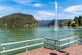 View of Lake Lugano-Ceresio with fountain from Lavena Ponte Tresa lake shore. Royalty Free Stock Photo