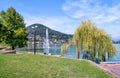 View of Lake Lugano - Ceresio with fountain from Lavena Ponte Tresa lake shore, Italy Royalty Free Stock Photo