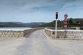 A view of the lake Marathon Greece bridge, road signs, traffic light on a sunny, spring day Royalty Free Stock Photo