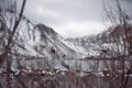 View of Lake on the Mountains in Winter Fog with Dramatic Snow Capped Mountains in the Background Royalty Free Stock Photo