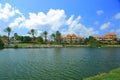 View of lake with palm trees and blue sky with white clouds on background Royalty Free Stock Photo