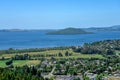 A view of Lake Rotorua with island and a city