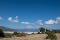 The view of Lake Salda, surrounded by dry grass, pine trees, and mountains, under a blue sky and clouds Royalty Free Stock Photo