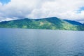 View from the top of Lake Toba hill with views of the hills and beautiful blue lake water Royalty Free Stock Photo