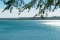 View of the lake from under the branches of a tree. Natural landscape Royalty Free Stock Photo