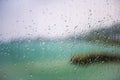 View of the lake through a window with wet glass Royalty Free Stock Photo