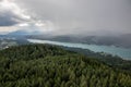 View from Lake WÃÂ¶rther See in the Austrian Alps overlooking a beginning storm with dark clouds and rain