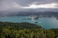 View from Lake WÃÂ¶rther See in the Austrian Alps overlooking a beginning storm with dark clouds and rain