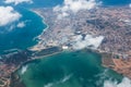 View of land from aircraft, blue sea, above the clouds Royalty Free Stock Photo