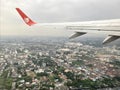 View from a landing airplane out the window of the city at sunset. Aerial panoramic cityscape view of Bangkok, Thailand