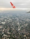 View from a landing airplane out the window of the city at sunset. Aerial panoramic cityscape view of Bangkok, Thailand