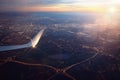 View from landing airplane window of city at sunset Royalty Free Stock Photo