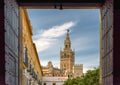 View of landmark Giralda tower as seen from Seville Cathedral patio doors. Royalty Free Stock Photo