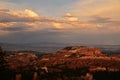 View of the landscape of Bryce Canyon after sunset with the last sunrays still lighting up the clouds above Royalty Free Stock Photo