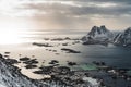 View of a landscape of a Norwegian fjord with a snowy mountain and rocks, Lofoten Islands