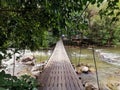 View landscape and suspension wooden bridge crossing Hat Som Paen canal stream waterfall and public garden park for thai people Royalty Free Stock Photo