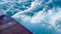 View of a large boat's stern. Yacht 's stern. Blue water footprint on the water